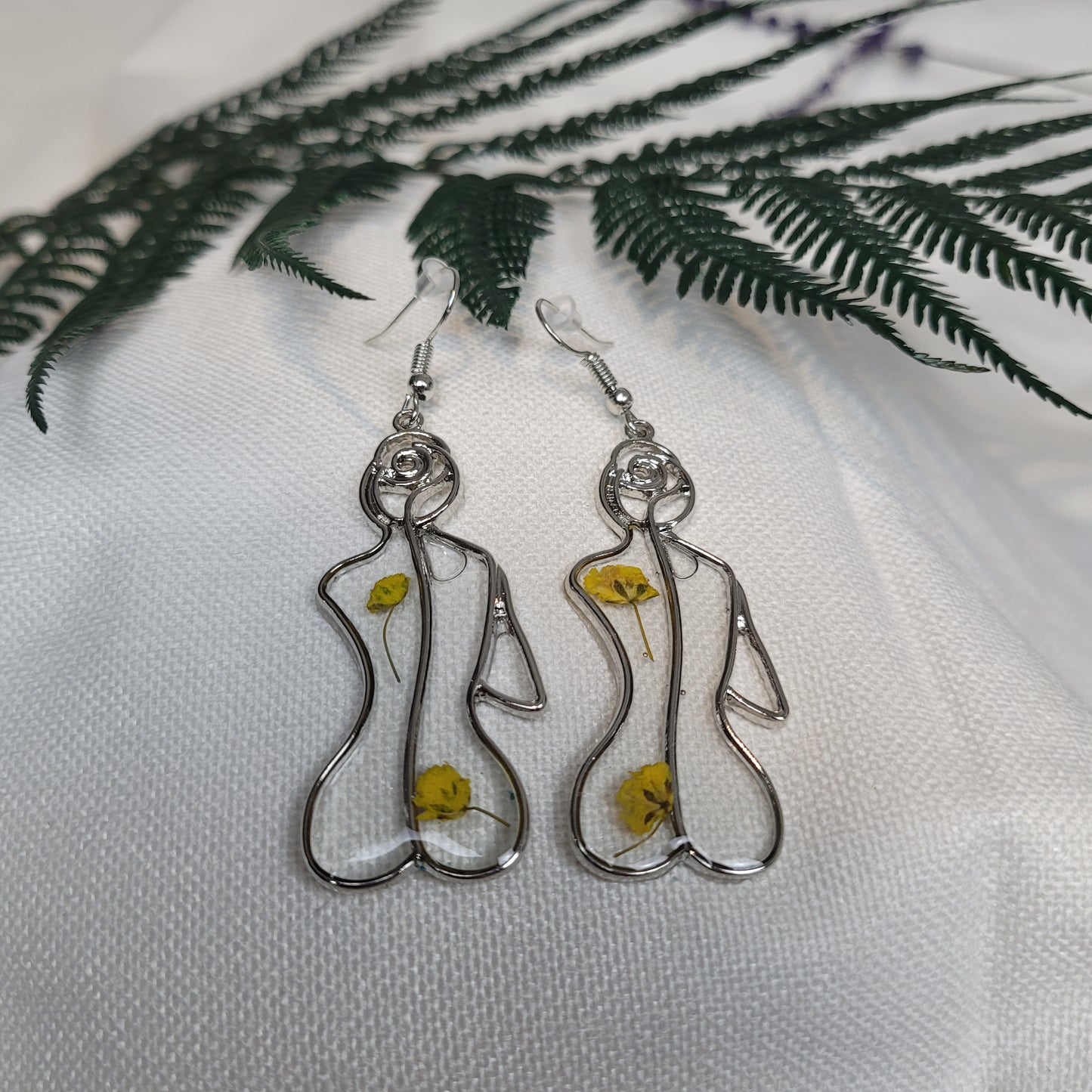 Silver colour floral bust and figure earrings