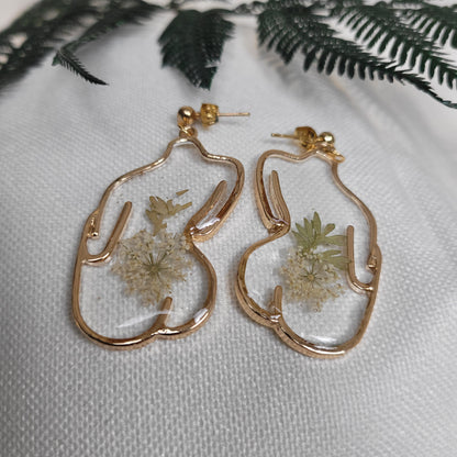 Gold colour floral bust and figure earrings