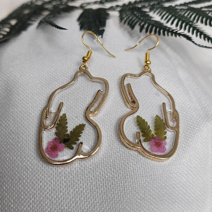 Gold colour floral bust and figure earrings